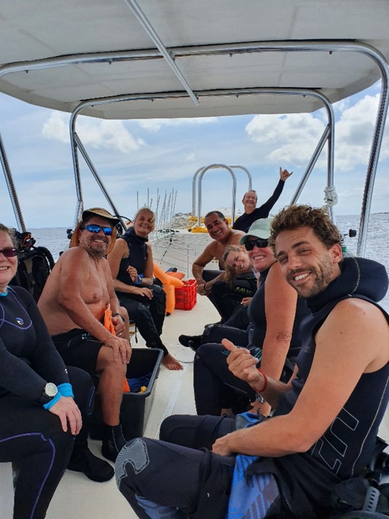 coral reef volunteers on a boat dive to do fieldwork